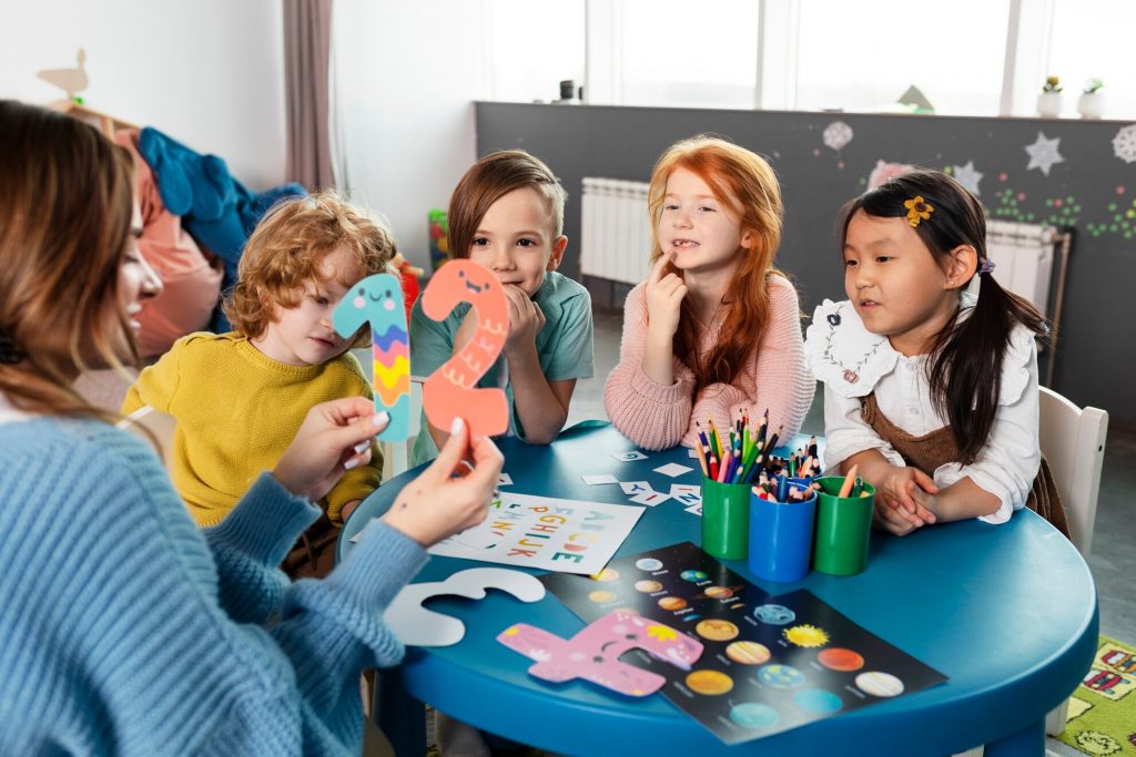 a group of children sitting around a table
